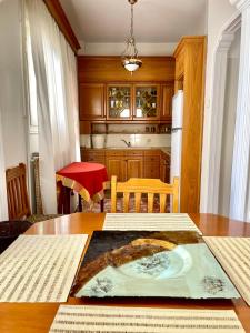 a kitchen with a table with a painting on it at Zoe's House Skiathos. Centre of Skiathos in Skiathos