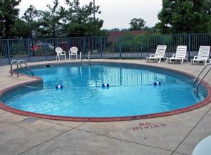 a small swimming pool with chairs at Rodeway Inn Altoona in Altoona