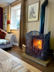 a living room with a wood burning stove at The Old Dairy - Brosterfield Farm in Eyam