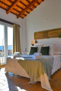 een slaapkamer met een groot bed met een groot raam bij La Esperanza in Medina Sidonia