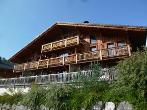 a large wooden house with balconies on a mountain at Appartement Samoëns, 4 pièces, 6 personnes - FR-1-624-25 in Samoëns