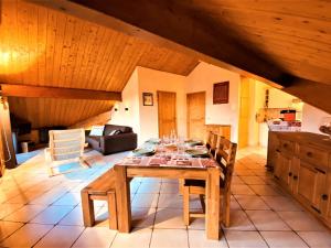 a dining room with a wooden table and chairs at Appartement Samoëns, 2 pièces, 5 personnes - FR-1-624-41 in Samoëns