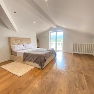 a bedroom with a bed and a large window at Venus House in Lamas +15 photos