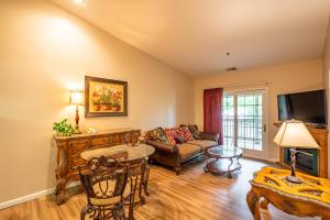 a living room with a couch and a table at Grand Wood Suites in Nashville