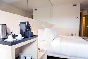 Schlafzimmer mit einem Bett und einer Kaffeemaschine auf der Theke in der Unterkunft Park Hotel Porto Valongo in Valongo