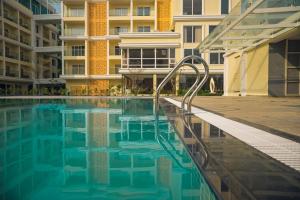 a swimming pool in front of a building at Antique Regency in Digha