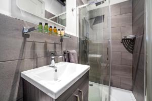 a bathroom with a sink and a shower at Modern Luxury Studios London in London