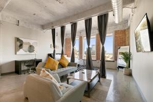 a living room with two couches and a table at Luxury Downtown Dallas Stay by Amyfinehouse in Dallas