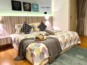 a bedroom with a bed with a hat on it at KL Gateway Residency in Kuala Lumpur