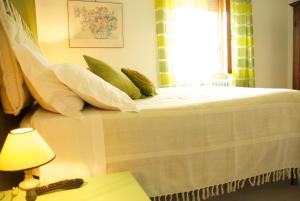 a bedroom with a bed with pillows and a window at Alle Terme B&B in Rapolano Terme