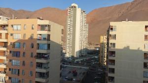 an aerial view of a city with buildings and mountains at Iquique todo el año in Iquique