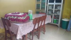 a table with a pink table cloth on top of it at HOMESTAY PARAK KAYU in Baso