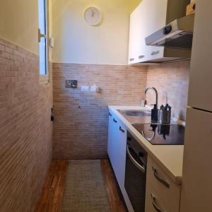 a small kitchen with a sink and a refrigerator at Julia nel cuore di Trastevere in Rome
