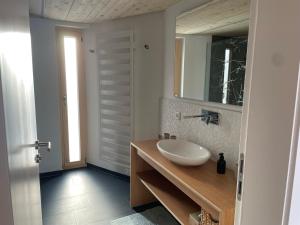 a bathroom with a sink and a mirror at Waidlerland Waldkirchen Chalets in Waldkirchen