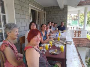 a group of people sitting at a table eating at Hebron Inn in Cochin