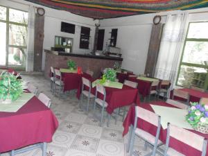 a restaurant with tables and chairs with red table cloth at Lalibela Hotel in Lalibela