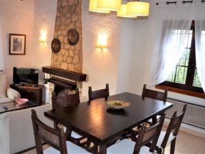 a dining room with a table and a fireplace at Villa Anna in Begur