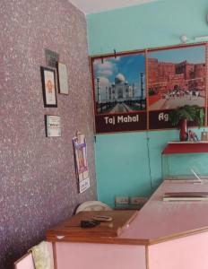 a room with a table and a sign on the wall at Krishna Guest House By WB Inn in Agra