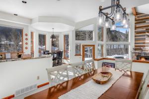 a kitchen and dining room with a table and chairs at 4551 Streamside Cir WEST HOUSE in Vail