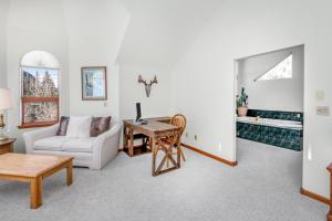 a living room with a couch and a table at 4551 Streamside Cir WEST HOUSE in Vail