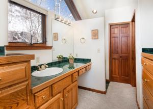 a bathroom with a sink and a mirror at 4551 Streamside Cir WEST HOUSE in Vail +51 photos