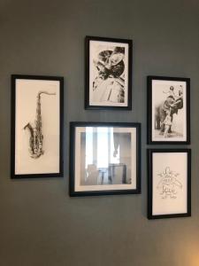 a group of framed pictures on a wall at Atelier Arthaud in Brest
