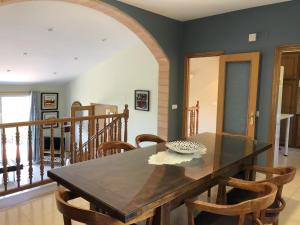a dining room with a wooden table and chairs at Villa Rosa in Begur