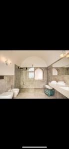 a large bathroom with two sinks and two toilets at VILLA OLGA LUXURY CAPRI in Capri