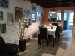 a dining room with a white table and chairs at La casa de los murales in Avellaneda