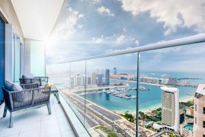 a balcony with a view of the ocean and a city at LUX - Lavish Suite with Full Palm Jumeirah View 2 in Dubai