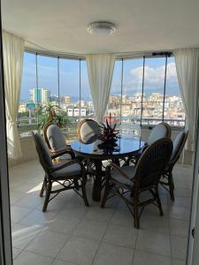 a table and chairs on a balcony with a view of a city at Gold Sun 4 in Mahmutlar