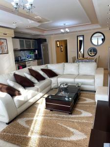 a living room with a white couch and a coffee table at Gold Sun 4 in Mahmutlar