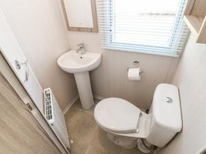 a small bathroom with a toilet and a sink at 17 Summer Meadows in Ashington +25 photos
