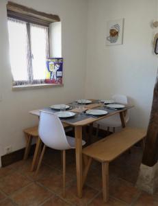 a dining room with a table and chairs and a window at La Chouette Burgonde in Villy-le-Moutier