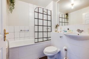 a white bathroom with a toilet and a sink at Cosy 2BR Modern Apt with Free Parking in Liverpool
