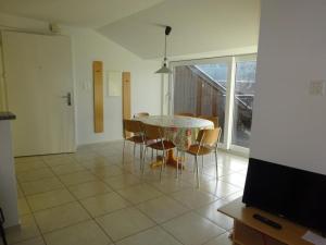 a dining room with a table and chairs and a television at Rehalp Westen in Bischofszell