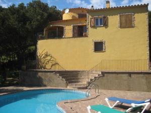 a house with a swimming pool in front of a house at La gervaise in Begur