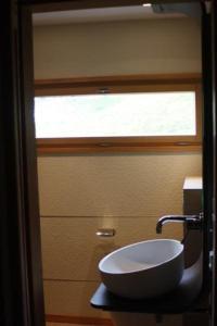 a bathroom with a sink and a window at Unterkunft MECK-HEI in Wildhaus