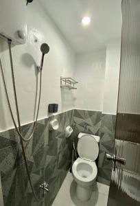 a bathroom with a shower with a toilet in it at The Tiny Room Apartment Units near Anonas and Cubao in Manila