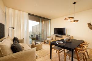 a living room with a couch and a table at Palmares Signature Apartments in Lagos
