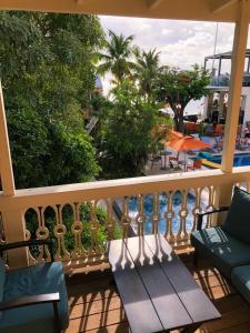 a balcony with a bench and a view of a pool at The Fred - Adults only Hotel in Frederiksted