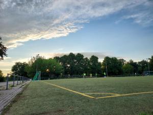 an empty soccer field with a soccer goal at Cosy Place for one/two in Berlin