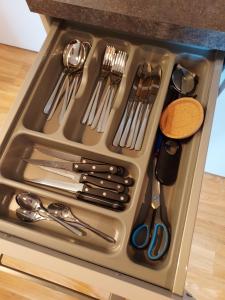 a tray filled with utensils sitting on a kitchen counter at Cosy Place for one/two in Berlin