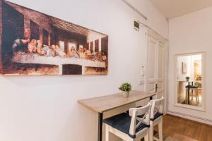 a dining room with a painting on the wall at By Galata- Historical and Modern Apartment in Istanbul