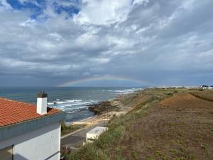a view of the ocean with a rainbow in the sky at Best Houses 73 - Lovely view São Bernardino in Atouguia da Baleia