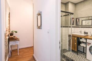 a bathroom with a shower and a sink at By Galata- Historical and Modern Apartment in Istanbul