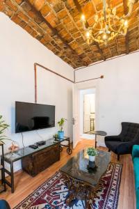 a living room with a couch and a tv at By Galata- Historical and Modern Apartment in Istanbul