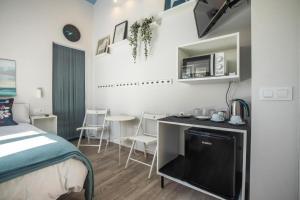 a bedroom with a bed and a desk with a tv at Finca El Campo in Algeciras