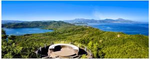 a view of the ocean from a hill with a bridge at Maison familiale avec jardin au Vauclin, proche de la mer in Le Vauclin