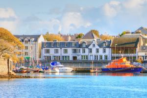 a group of boats are docked in a harbor at Royal Hotel in Stornoway